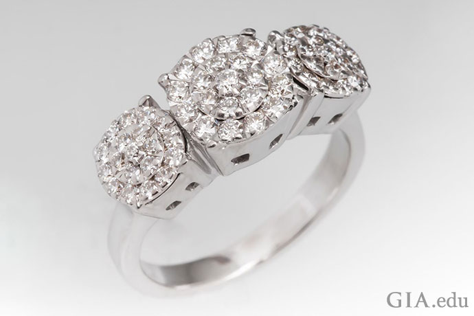 A cluster engagement ring setting creates the illusion of three large gems.