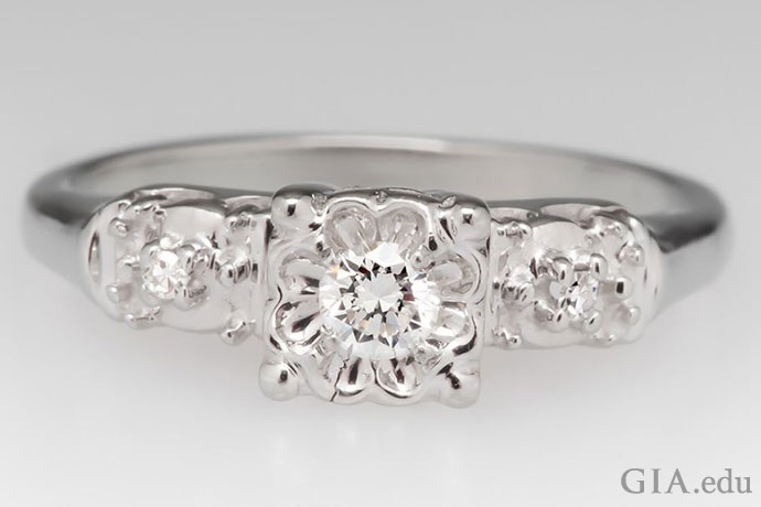 A round brilliant diamond engagement ring in an illusion setting.