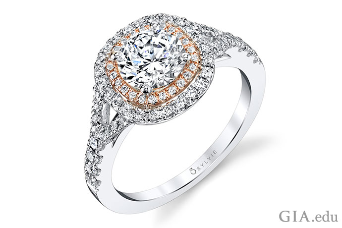 A 1 ct round brilliant diamond engagement ring surrounded by a double halo of melee diamonds set in white and rose gold.