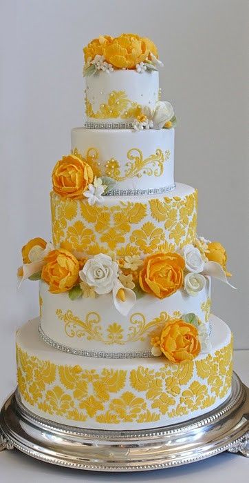 Bright and delicate 5-tiered cake with fresh flowers by Couture Cakery.