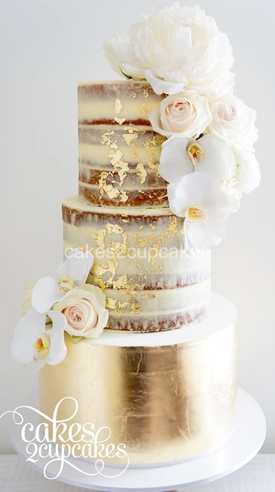 Half dressed or semi-naked wedding cake with gold leaf and fresh flowers by Cakes2Cupcakes.