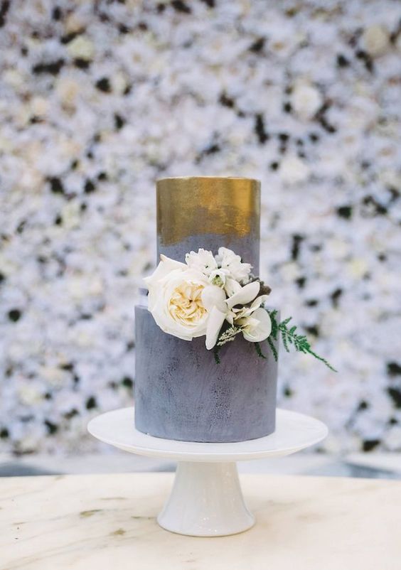 This wedding cake from Sweet Bakes boasts modern elegance with its golden pattern and clean lines.