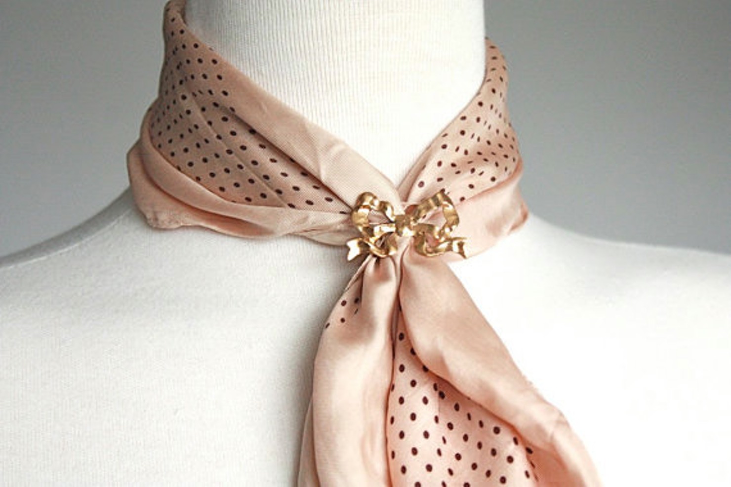 Tie a scarf with a brooch