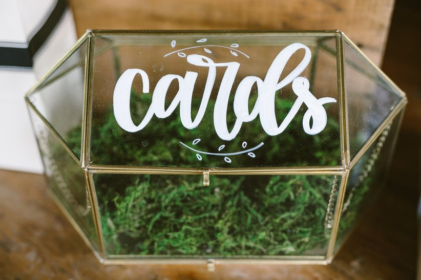 glass geometric box with "CARDS" written in white calligraphy on the top