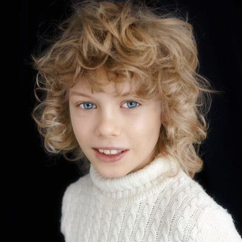 boy with blonde curly long hairstyle