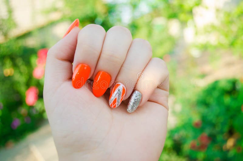 Perfect manicure and natural nails. Attractive modern nail art design. orange autumn design. long well-groomed nails.  royalty free stock photo