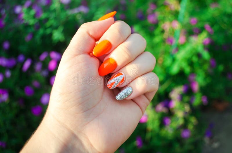 Perfect manicure and natural nails. Attractive modern nail art design. orange autumn design. long well-groomed nails.  royalty free stock photos