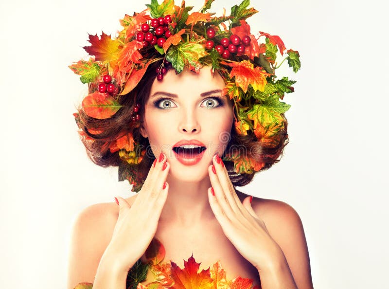 Red and yellow autumn Leaves on girl head. Autumn Beauty - fashion Makeup With Red and yellow autumn Leaves on girl head . Emotions and surprise on the face of stock photos